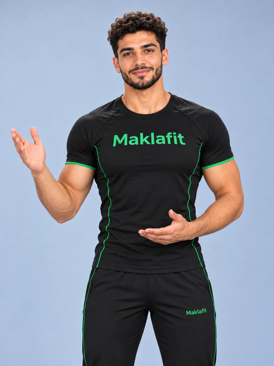 Karim in a black Maklafit training shirt, smiling and gesturing as he explains